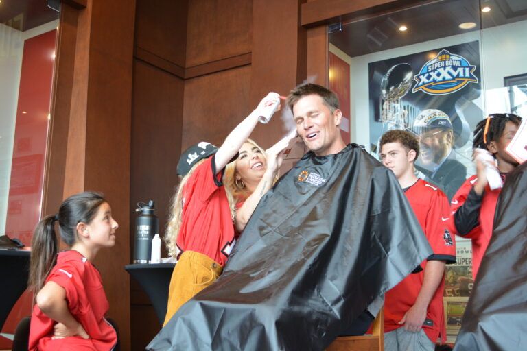 Laurel spraying Tom Brady's hair