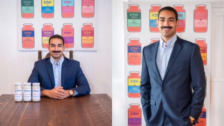 Yo Mama’s Foods founder David Habib poses in front of brand packaging displays and product bottles