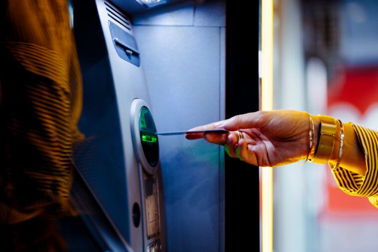 Close Up Photo Of Woman Hands Using ATM Machine