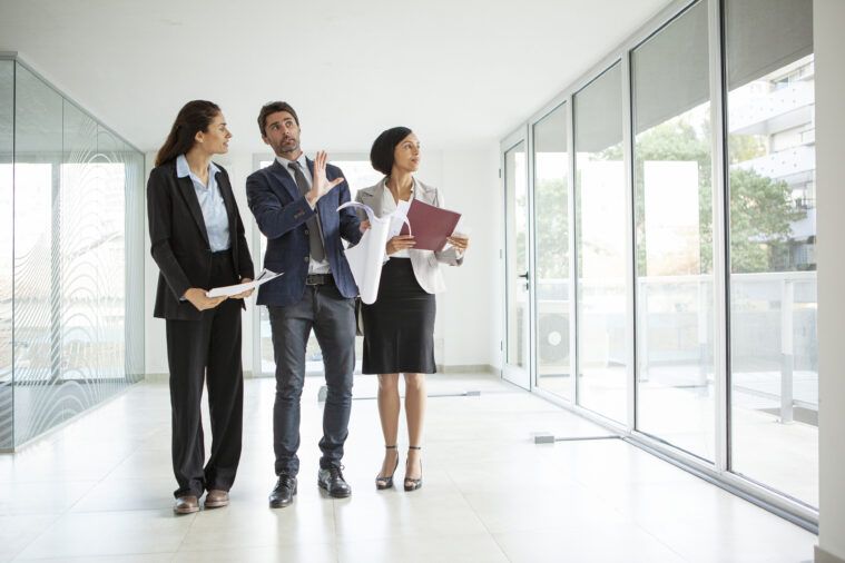 Latin male architect explaining project to businesswomen