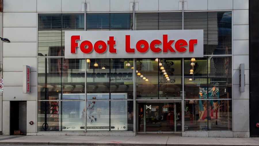 Exterior of a Foot Locker retail store with the company’s red and white logo displayed above the entrance.