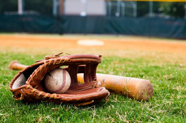 Old Baseball, Glove, and Bat on Field