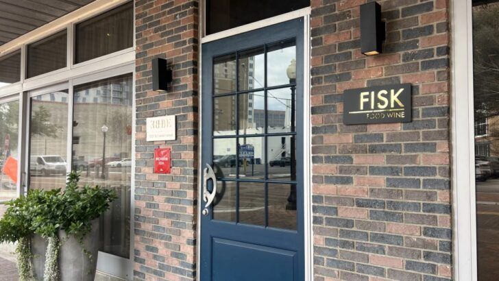 Entrance to Fisk Food & Wine in downtown Tampa, showing the restaurant’s sign and front door