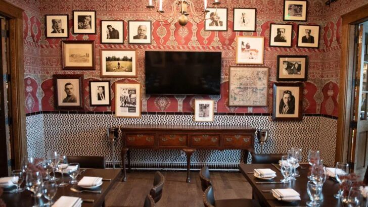 Interior dining room at Mad Dogs & Englishmen in Tampa, featuring framed photos and set tables