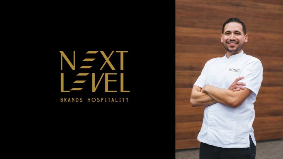 Chef Jacob Rios, newly appointed Director of Culinary at Next Level Brands, stands in his chef’s coat outside Union New American in Tampa.