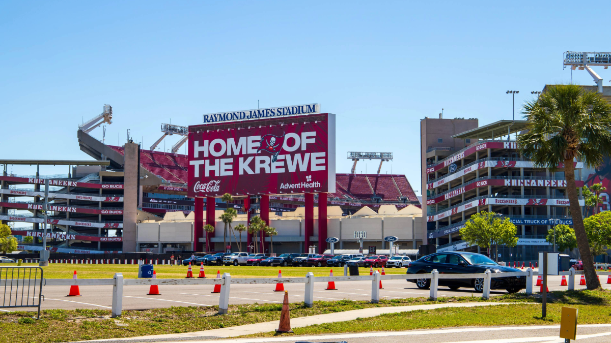 Exterior of Raymond James Stadium in Tampa, Florida, with “Home of the Krewe” signage and Buccaneers branding visible on a sunny day.