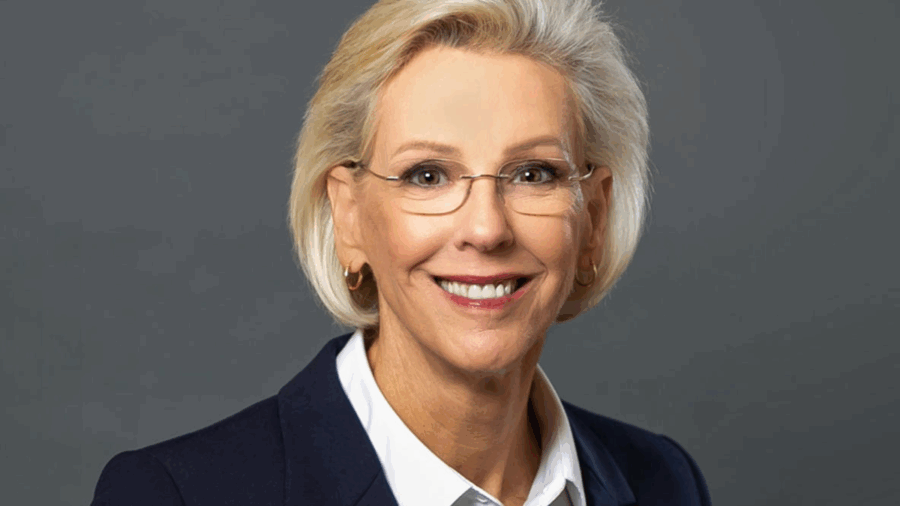 Tampa Mayor Jane Castor smiles in a professional headshot, wearing a navy blazer, white blouse and glasses.