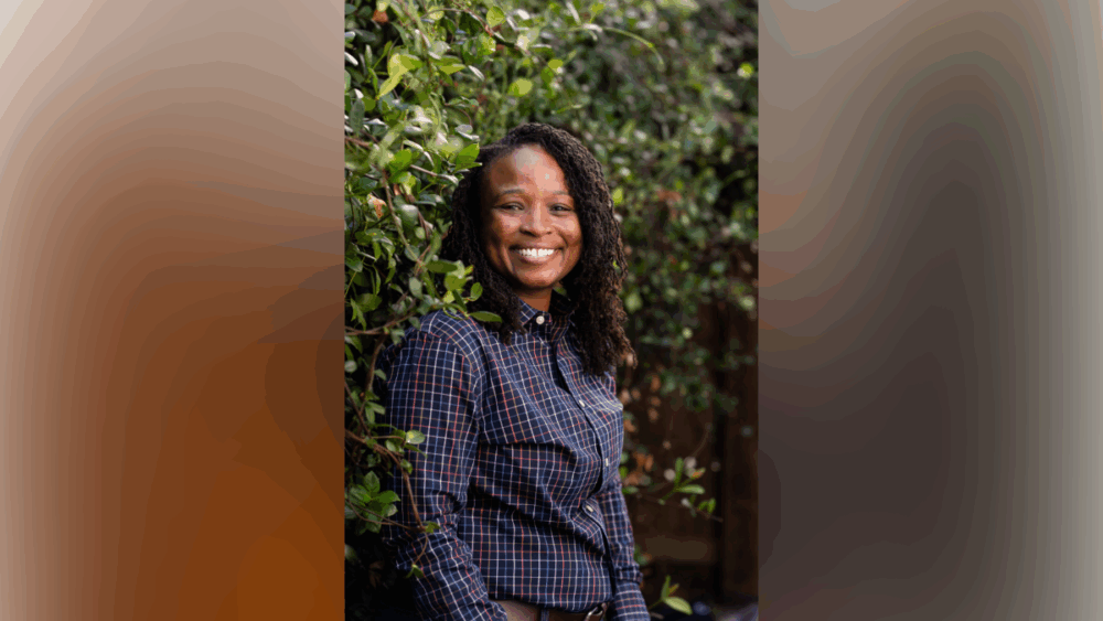 Ashley Butler smiling outdoors near greenery at her Tampa home.