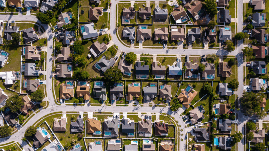 Aerial view of suburban homes in Tampa Bay, showing residential streets, backyards and pools.