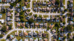 Aerial view of suburban homes in Tampa Bay, showing residential streets, backyards and pools.