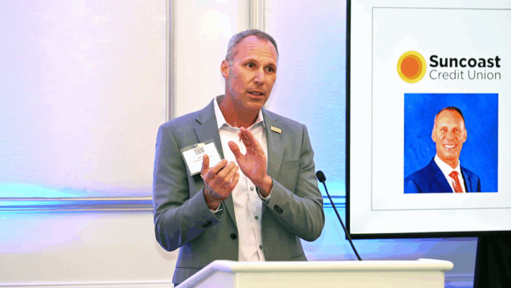 A speaker addressing attendees during the CEO Connect event focused on Tampa leadership and community impact.