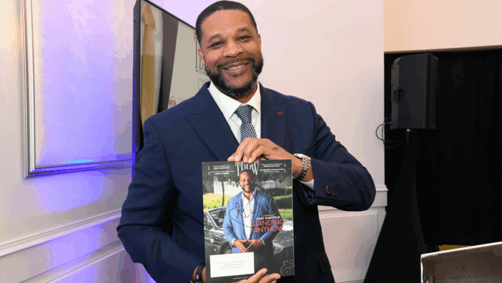 Gary Hartfield holds Tampa Bay Business & Wealth cover at CEO Connect.