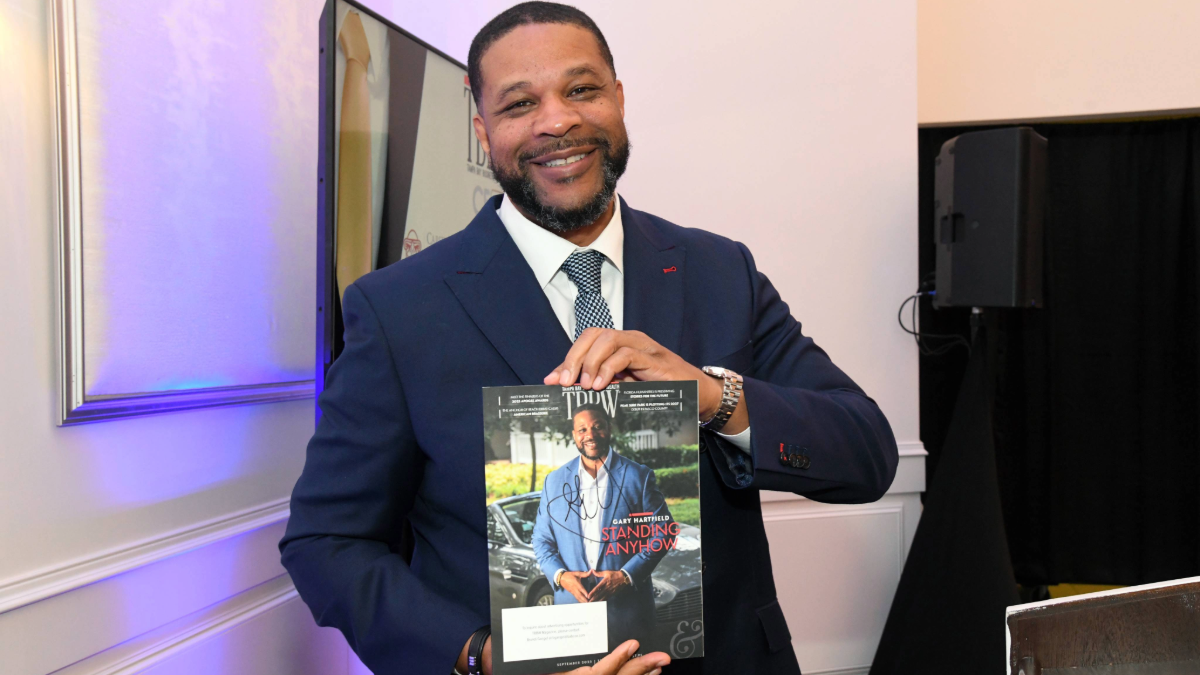 Gary Hartfield holds Tampa Bay Business & Wealth cover at CEO Connect.