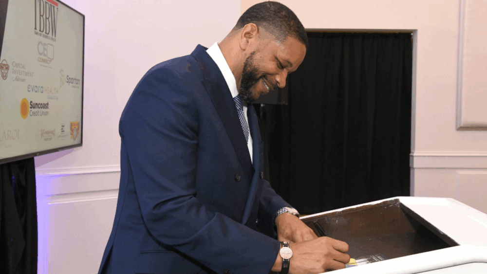 Gary Hartfield signing his cover of TBBW during a CEO Connect event in Clearwater. 