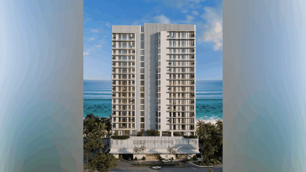 Nighttime rendering of the full Aston Martin Residences Daytona Beach Shores tower illuminated along the coastline.