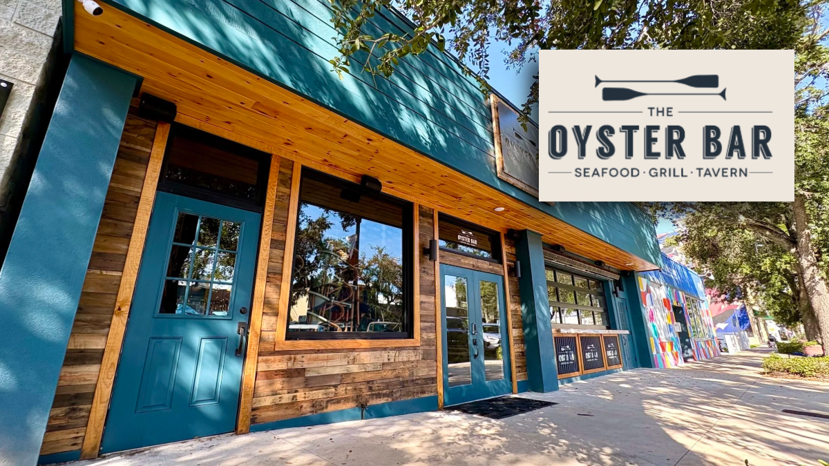 Exterior of The Oyster Bar restaurant in St. Petersburg’s Grand Central District featuring teal doors, wood paneling and the restaurant’s logo sign.