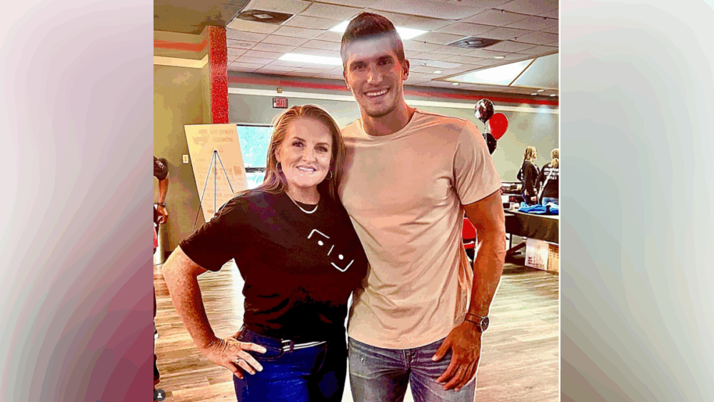 Teal Henderson posing with former Tampa Bay Buccaneers player Justin Watson at a Bones Investment Group event.