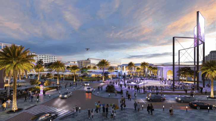 Plaza view rendering of the Gas Plant District featuring palm-lined streets, outdoor gathering spaces, and people walking in a lively evening scene.
