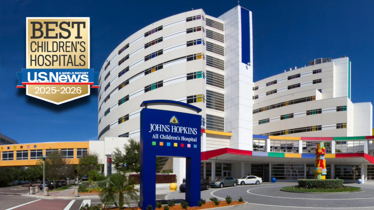 Exterior view of Johns Hopkins All Children’s Hospital in St. Petersburg, Florida, featuring the hospital’s colorful facade and the U.S. News & World Report “Best Children’s Hospitals 2025–2026” badge.
