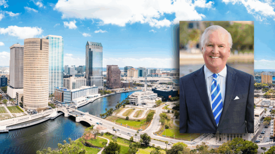 A view of downtown Tampa, Florida, with the Hillsborough River in the foreground and high-rise office buildings along the waterfront. Inset is a portrait of former Tampa Mayor Bob Buckhorn wearing a navy suit and blue striped tie, smiling outdoors.