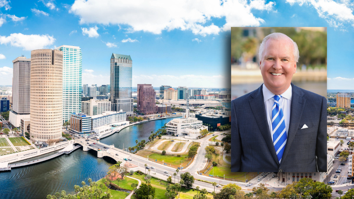 A view of downtown Tampa, Florida, with the Hillsborough River in the foreground and high-rise office buildings along the waterfront. Inset is a portrait of former Tampa Mayor Bob Buckhorn wearing a navy suit and blue striped tie, smiling outdoors.