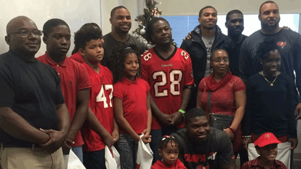 Doug Martin and fellow Tampa Bay Buccaneers players host a holiday event for local families at team headquarters in 2015.