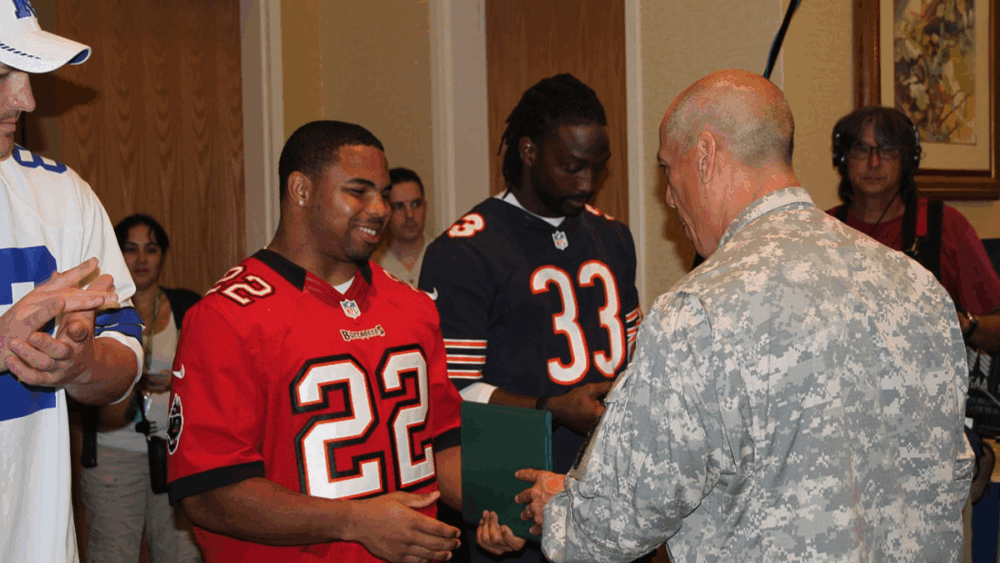 Doug Martin receives a certificate of appreciation from a U.S. Army officer at Schofield Barracks during the 2013 Pro Bowl week.