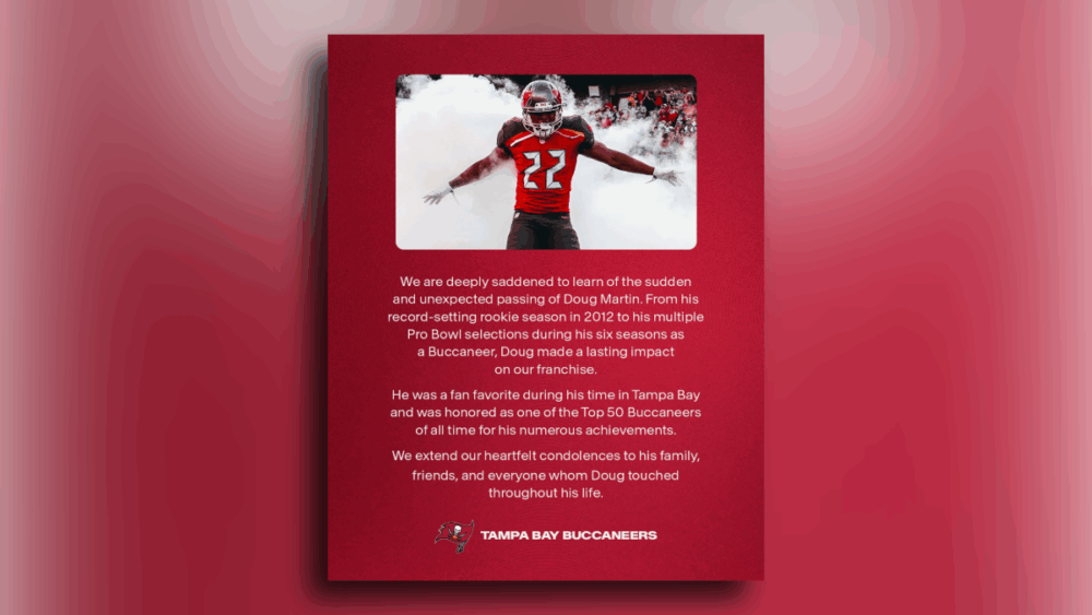 Doug Martin runs onto the field through smoke before a Tampa Bay Buccaneers game.