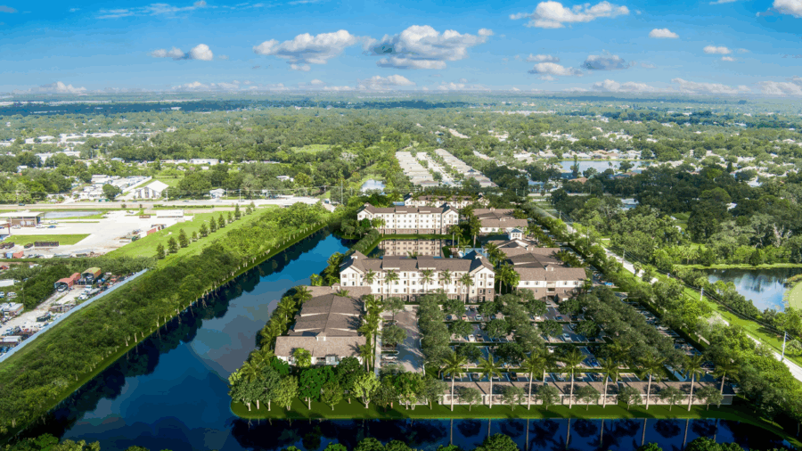 Aerial rendering of Alton Sarasota apartment community surrounded by water and greenery.