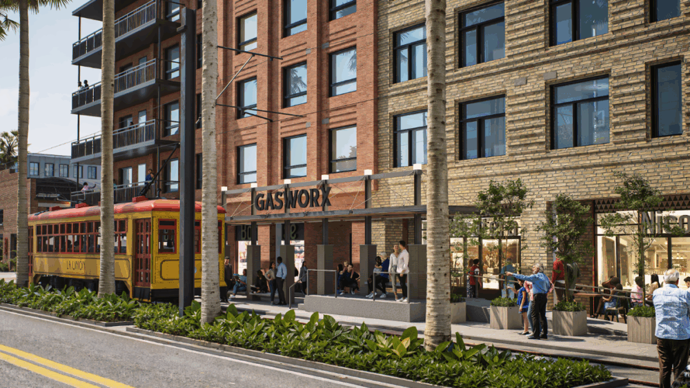 Street-level rendering of Gasworx featuring a passing streetcar and brick-lined retail corridor.