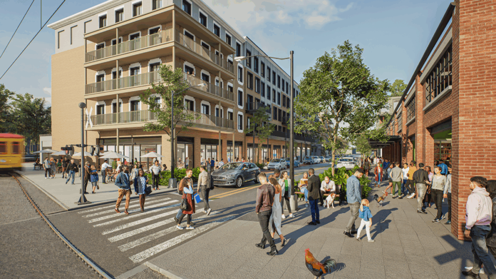 Street-level rendering of Ybor City’s Gasworx district with pedestrians, outdoor dining, and a passing streetcar.