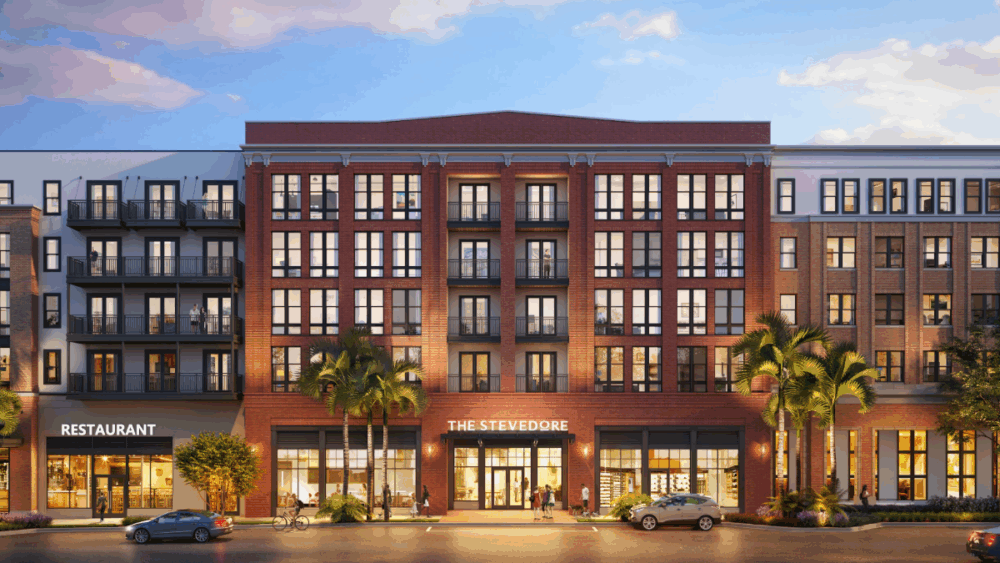Front view of The Stevedore at Gasworx, showing red-brick architecture with ground-floor retail and residential balconies.