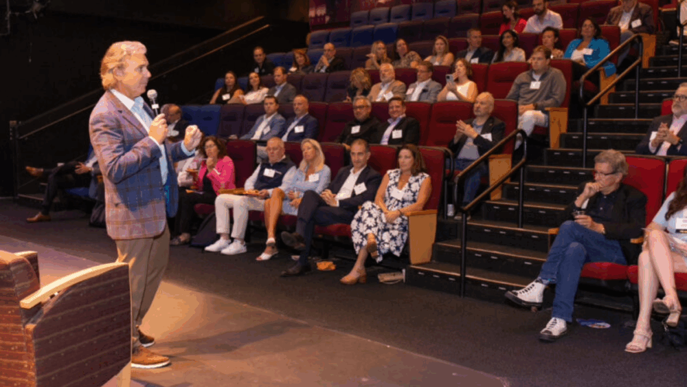 A speaker addresses an audience of Tampa Bay professionals during a Tampa Bay Business & Wealth event.