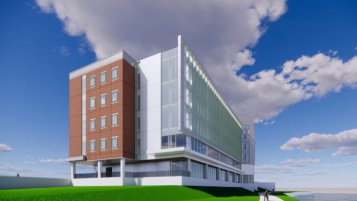 River side view of UTampa’s new science building with tall glass panels.