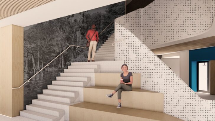 Stair seating area and large wall mural inside UTampa’s new science building.