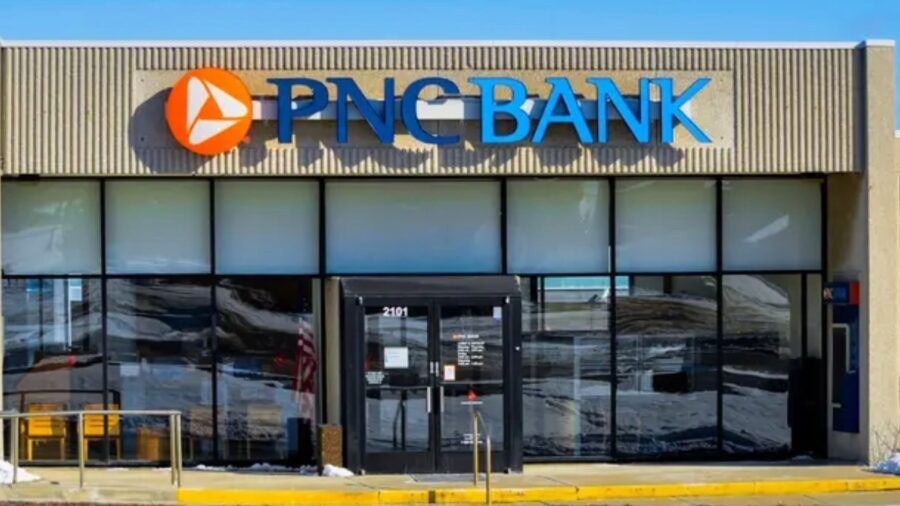PNC Bank branch exterior with signage and outdoor seating area.