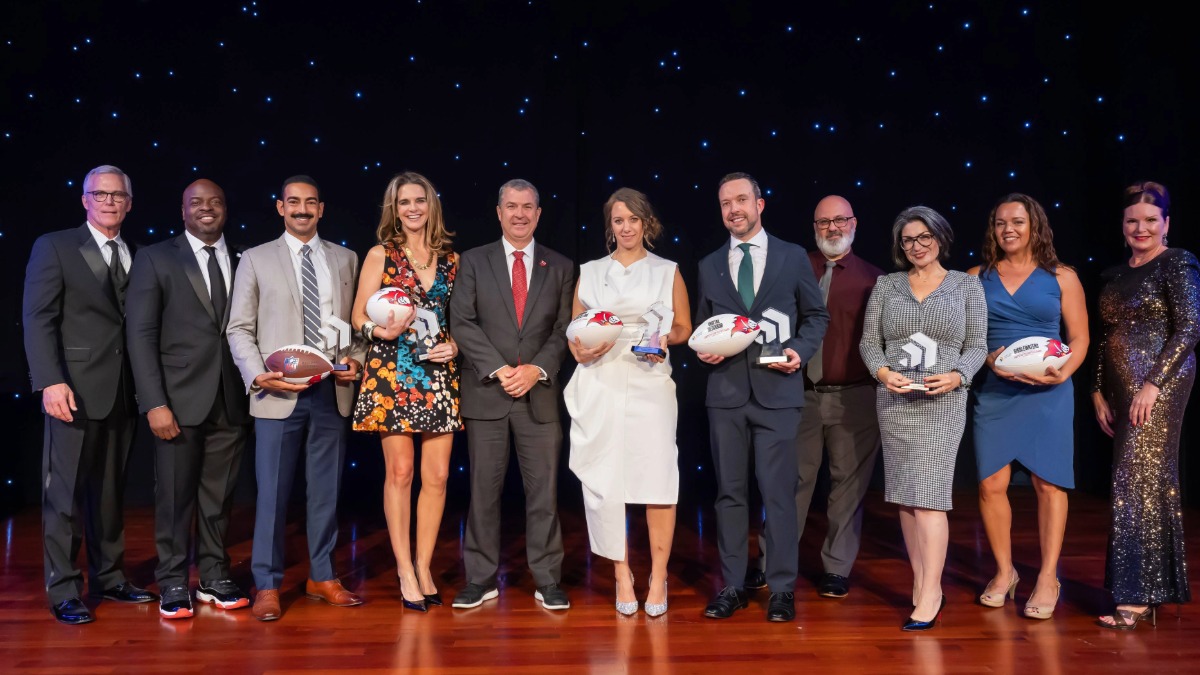 Group photo of the 2025 Tampa Bay Chamber Small Business of the Year Award winners and Chamber leadership posing on stage at the Straz Center in Tampa.
