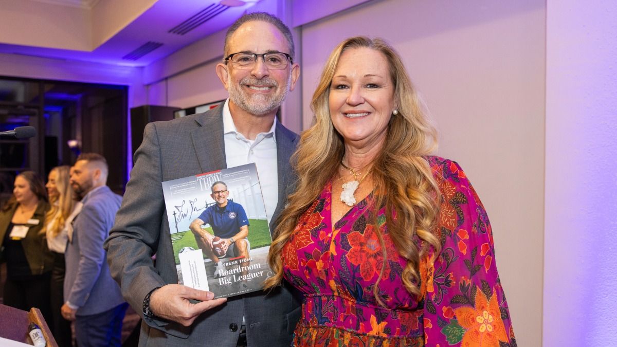 Frank Fiume and Bridgette Bello smiling together as Fiume holds the TBBW magazine featuring his cover story
