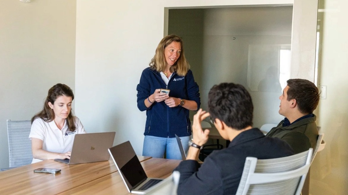 SkyTL founder Rocio Frej Vitalle leads a strategy session with her team in Tampa, focusing on AI-driven water quality technology.