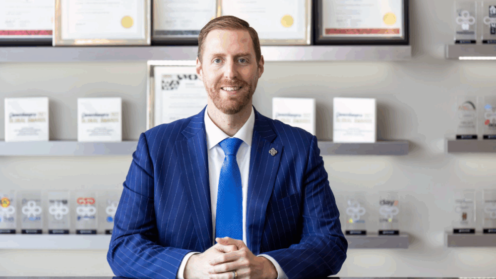Tyrus O’Neill of Benchmark International sitting at a table inside the firm’s Tampa headquarters