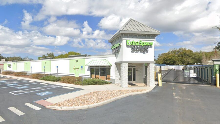Exterior of Extra Space Storage facility in Valrico, Florida, showing entrance, parking area, and building signage.