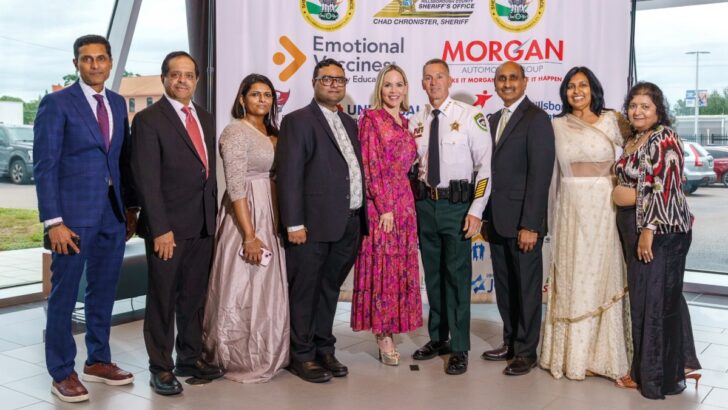 Sheriff Chad Chronister presents an award on stage alongside Council leaders during the 2025 Annual Banquet.