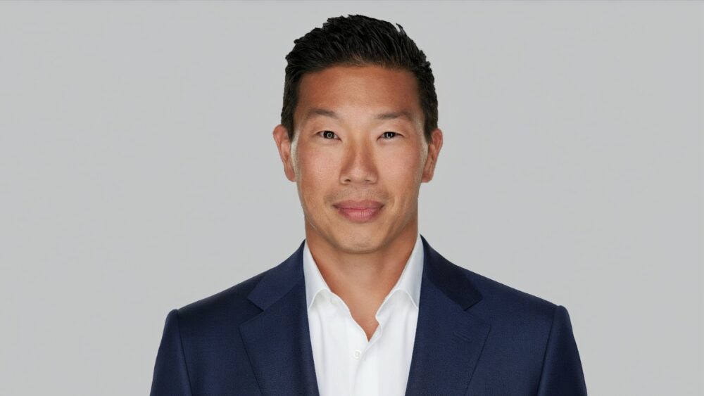 Jay Roberts, CEO of Prosper Group, photographed in a navy suit against a neutral background.