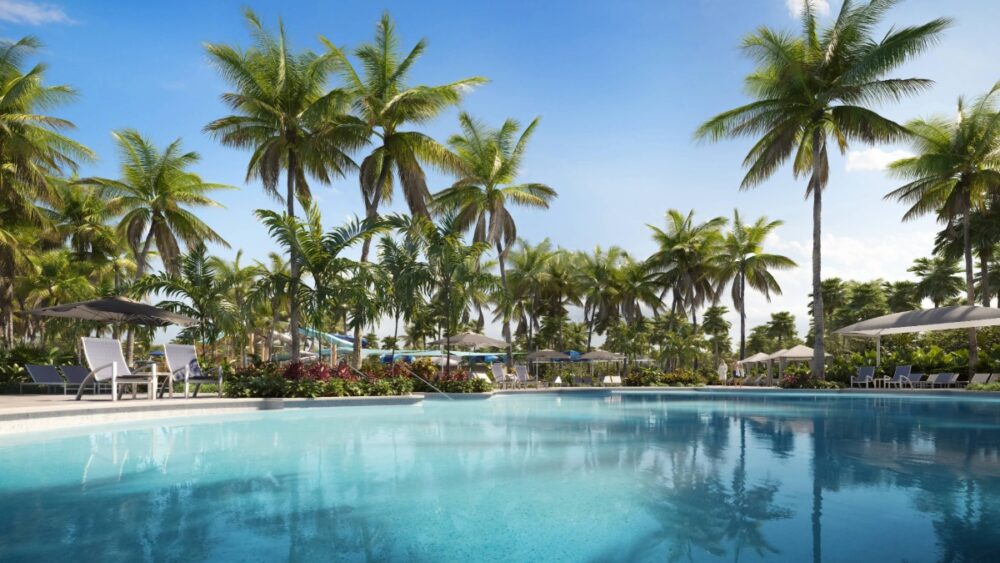 South Seas Resort Pool View Pool area at South Seas framed by palm trees with lounge chairs and tropical landscaping.