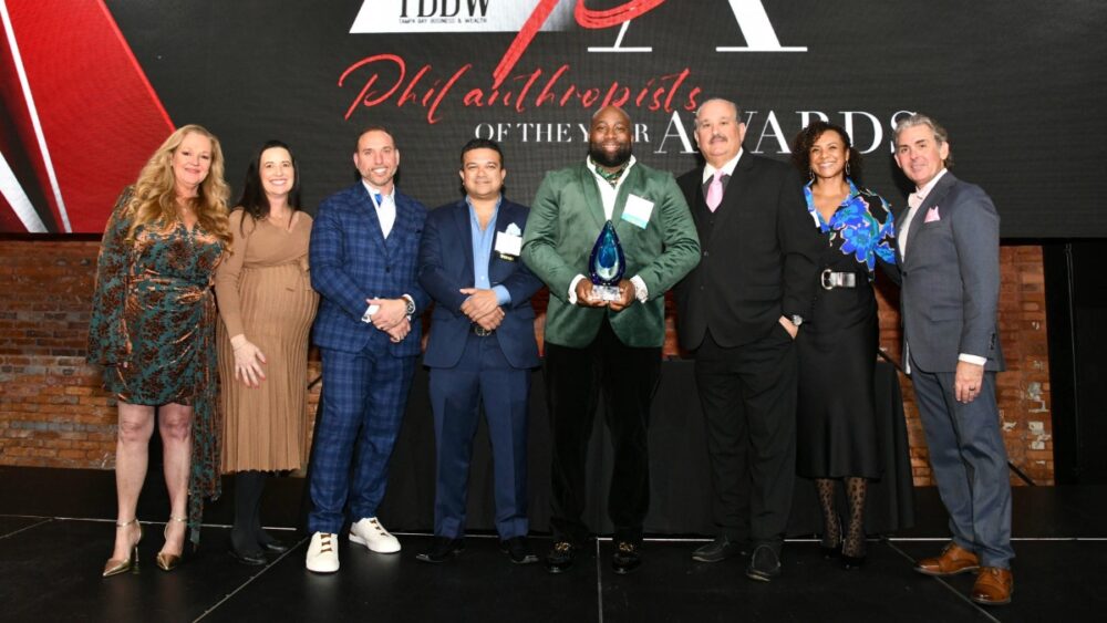 Group photo on stage during the presentation of the Lifetime Achievement Award at the 2025 TBBW Philanthropists of the Year Awards.