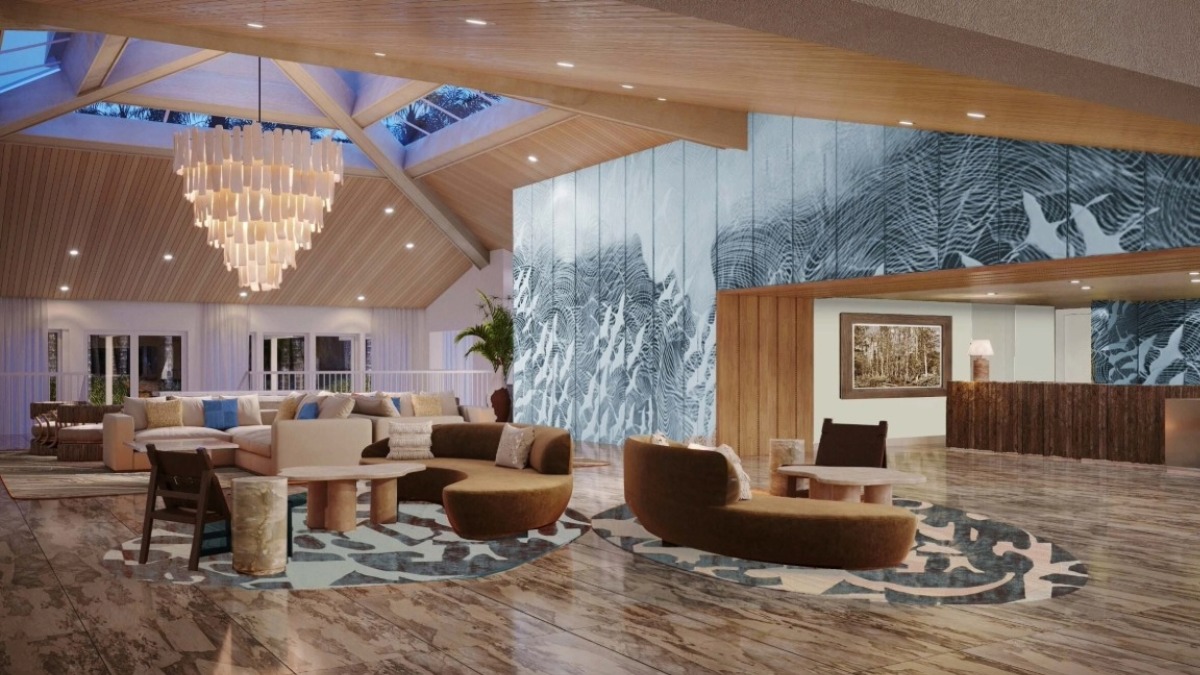 The renovated lobby at Saddlebrook Resort with a large chandelier, modern seating and a blue textured feature wall.