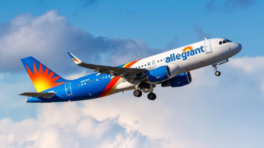 Allegiant Air jet taking off against a blue sky with clouds