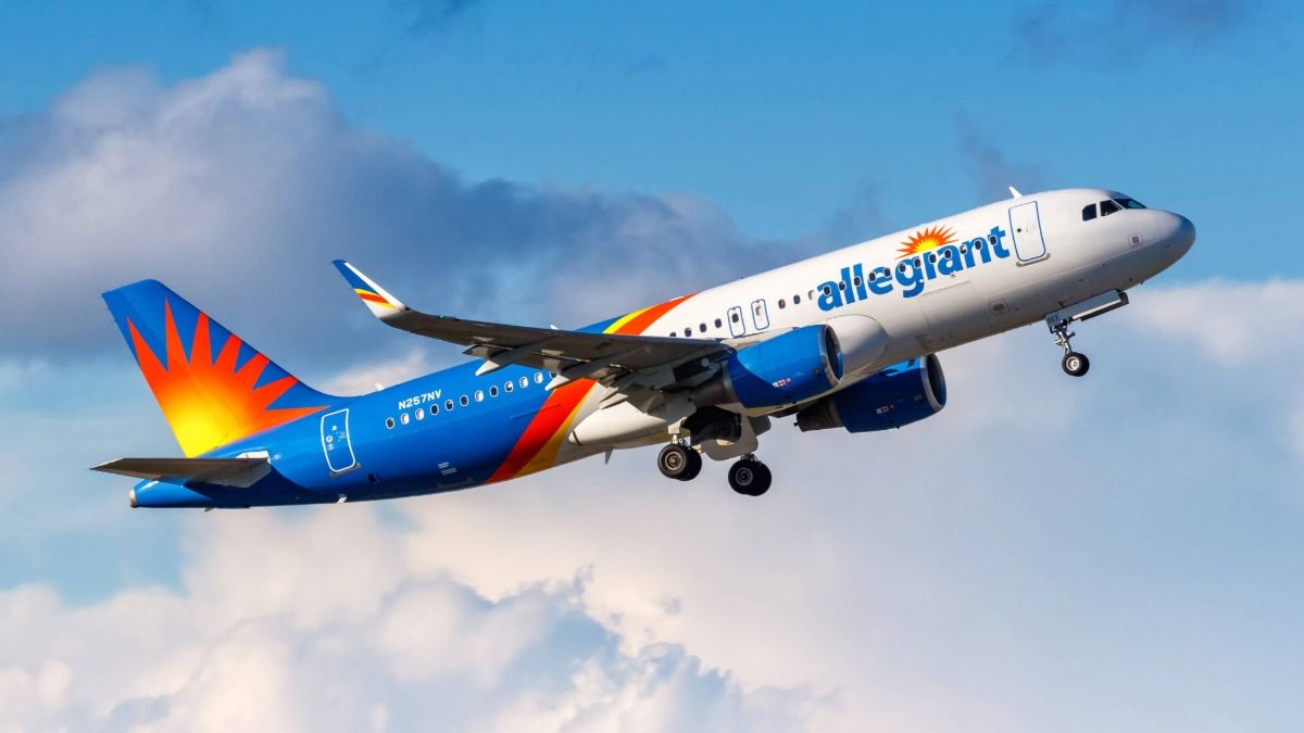 Allegiant Air jet taking off against a blue sky with clouds
