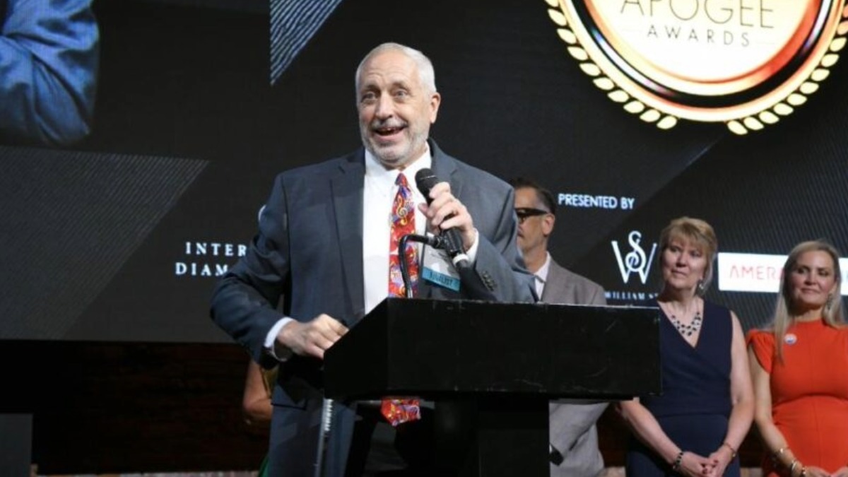 Steve King accepts his award at TBBW Apogee Awards while speaking from the stage.