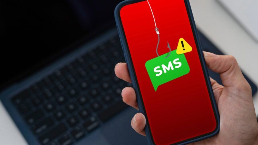 A smartphone screen displaying a phishing warning with a fishing hook above an SMS alert icon, symbolizing text-message scam attempts.